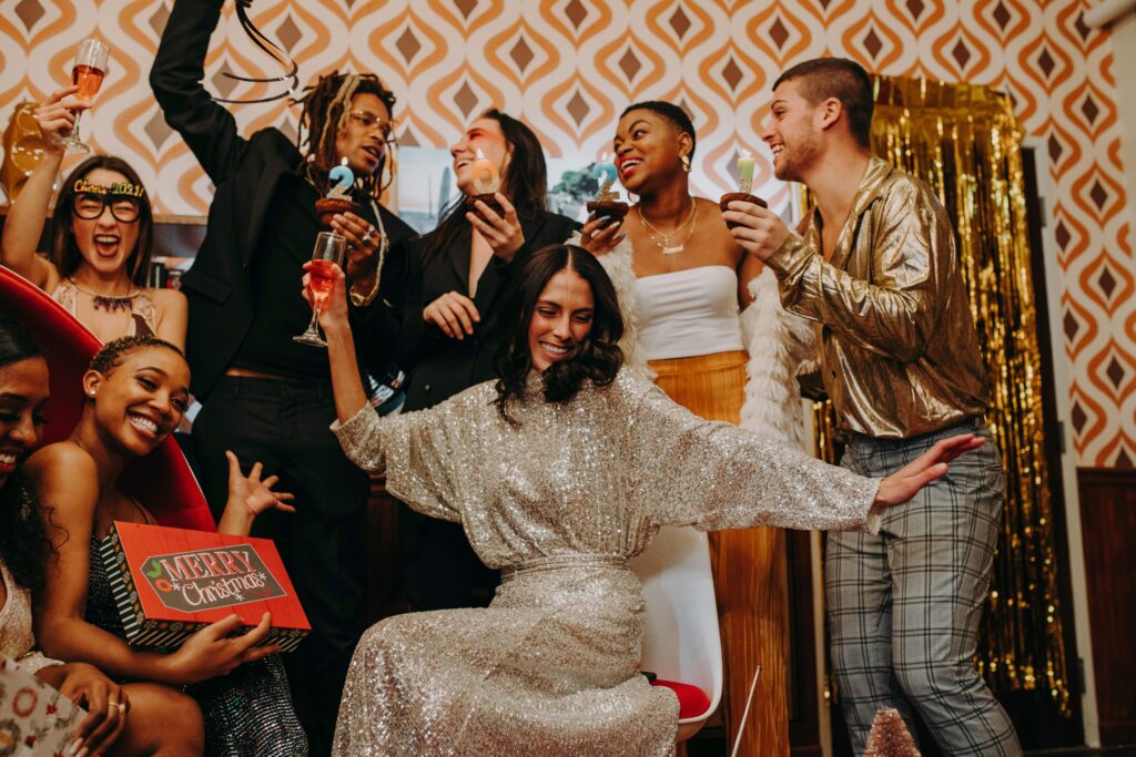 Group of friends celebrating a festive holiday party with joy and style indoors.